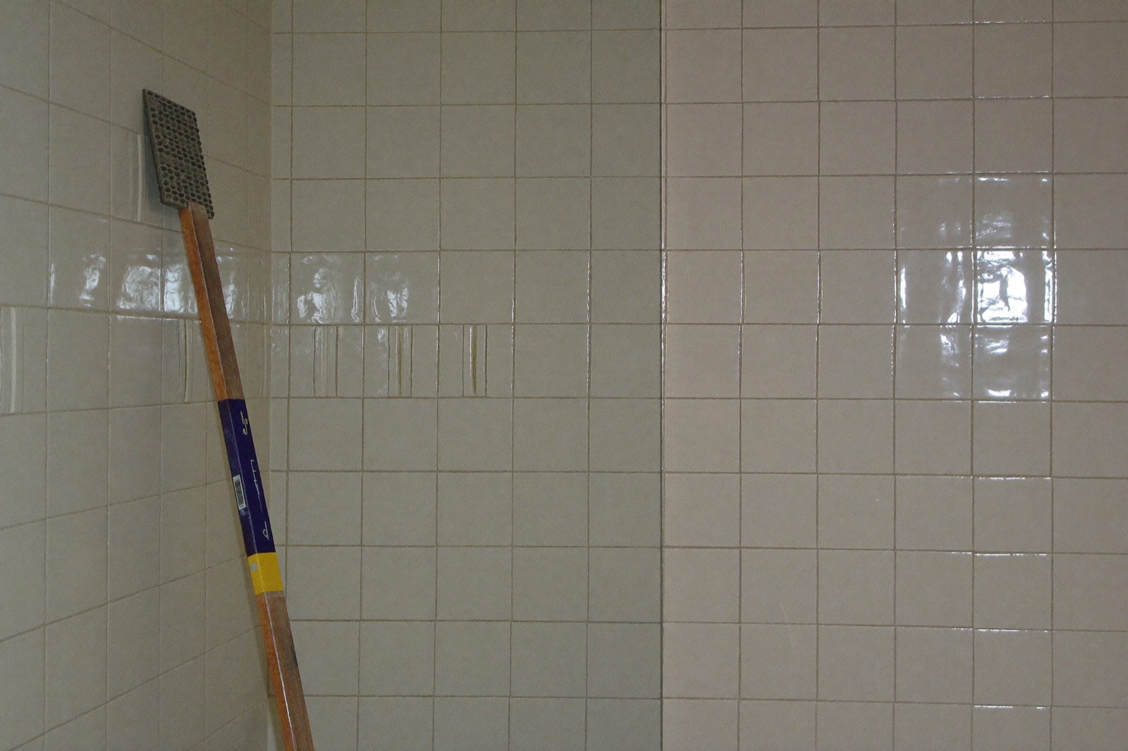 Tiling a bathroom shower wall with large-format porcelain — waterproofing and tile are the largest trade in bathroom remodel cost