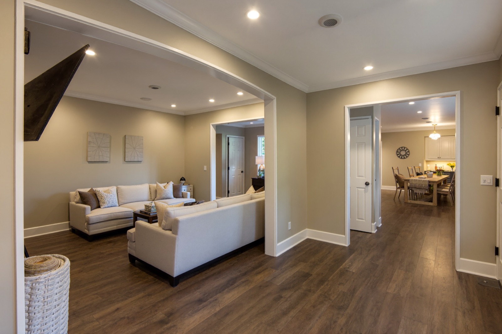 Finished basement rec room with recessed lighting and vinyl plank flooring — a cost to finish a basement calculator example