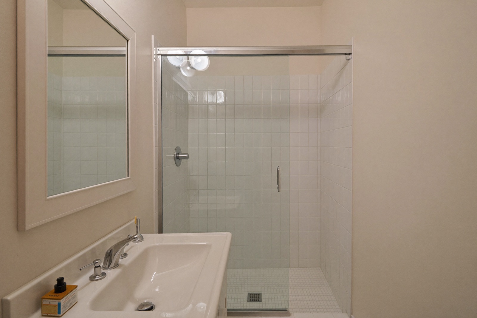 Finished small 5x8 bathroom with white vanity and tiled walk-in shower — a small bathroom remodel cost calculator example